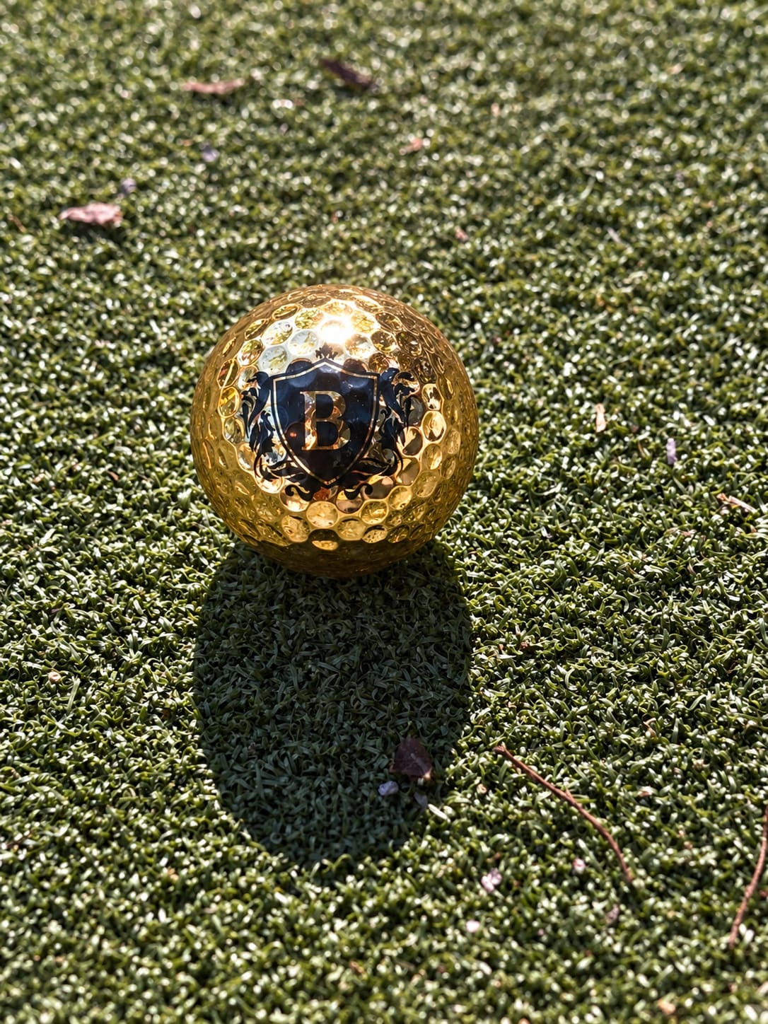 Gold Blackcrest-branded golf ball on the mini golf green